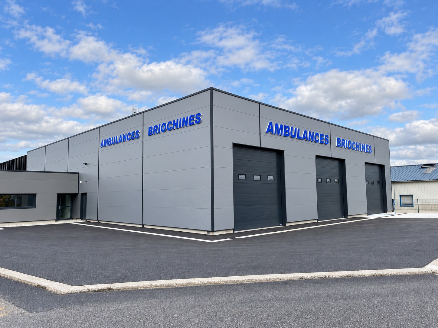 Bâtiment gris des Ambulances Briochines avec grandes lettres bleues sur deux façades